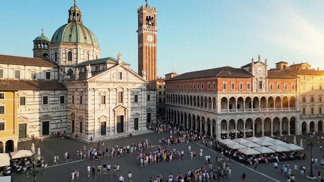 Historic Piazza dei Signori square in Vicenza city center, Italy. Beautiful architectural heritage featuring Palladian Basilica and clock tower at sunset. Famous UNESCO World Heritage site landmark.