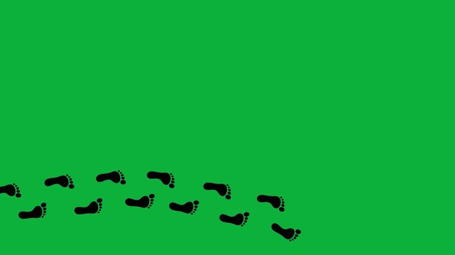 Trail of footprints on green screen background. Black silhouettes of footprints. Steps tracing the human path. Human journey of the footsteps. Step by step. 4K.