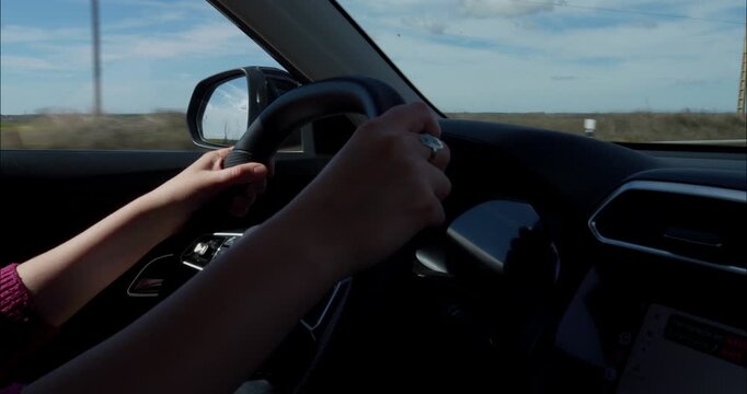 Woman driving down the roads of Spain in a sunny day