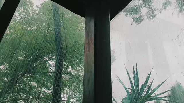Cozy rainy day glass window view with calming cinematic atmosphere