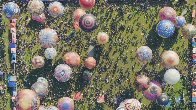 Overhead Crowd and Balloon Festival Scene with Long Shadows on Field