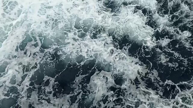 Turbulent ocean waves crash with white foam in this rhythmic water motion clip captured for cinematic production