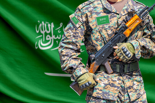 Saudi Arabia flag with soldier holding assault rifle