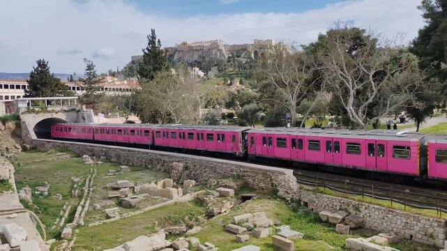 Metro train passing through the Ancient Agora of Athens, from Thiseio to Monastiraki station. Acropolis and Stoa of Attalos in the background, Athens, Greece.