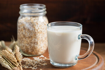 Oat milk in glass cup. Dairy free, gluten free, lactose free oat milk