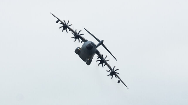 Dynamic Airbus A400M Atlas soaring through the clouds during a tactical airlift and aerial refueling mission