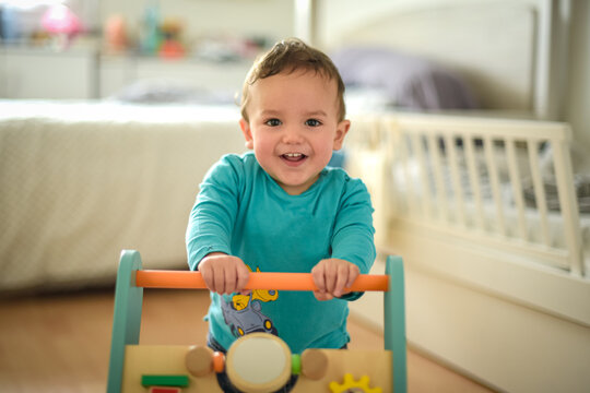 young child taking their first steps with a walker