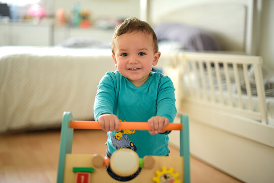 young child taking their first steps with a walker