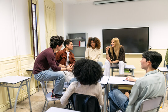 Diverse high school or college students sitting in a circle in a classroom, actively listening and discussing during a group activity