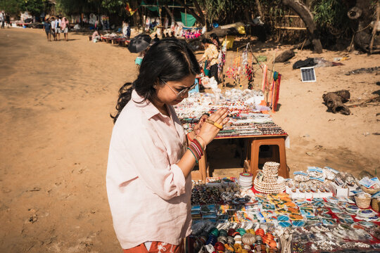 Woman enjoying shopping at a beach flea market in Om Beach, Gokarna, Karnataka, India