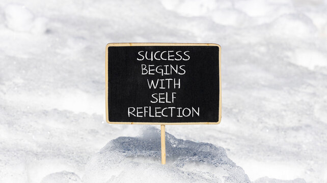 Self reflection symbol. Concept words Success begins with self reflection on beautiful black blackboard. Beautiful snow background. Business success begins with self reflection concept. Copy space.