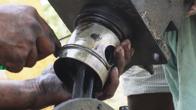 Mechanic Hands Repairing Engine Piston