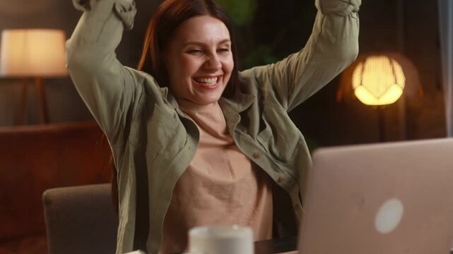 Amazed woman extremely happy after read message on computer at home Excited female looking at laptop screen and pleased rejoices received great successful news or result indoors