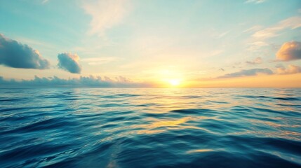 Fototapeta premium Sunrise over the ocean creates a view of waves and clouds in the early morning sky