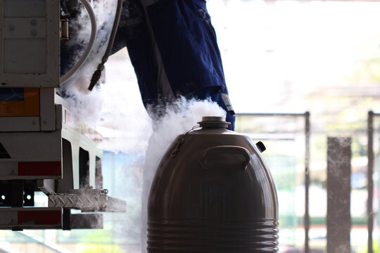 Liquid nitrogen is being transferred from container, creating cloud of vapor. scene dynamic interaction between cold substance