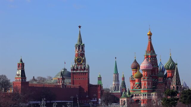 A picturesque view of the Kremlin featuring its iconic golden domes and towers against a vibrant sky, epitomising the historical and architectural grandeur of Russia.