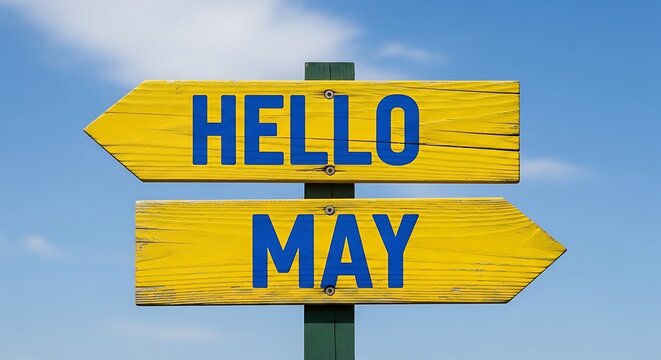 Hello May greeting on yellow wooden directional sign, rustic spring season wooden signpost, seasonal welcome message against blue sky background