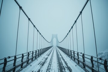 Obraz premium A massive, empty suspension bridge swaying slightly in a fierce, snow blinding gale.