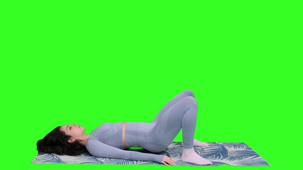 Naklejka premium Sporty young woman training her legs on the yoga mat on the chroma key