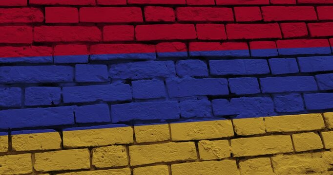 A panning video of a brick wall with the armenia flag