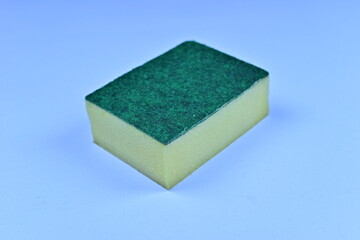 Fototapeta premium Single yellow sponge with a green abrasive scouring pad isolated on a white background.