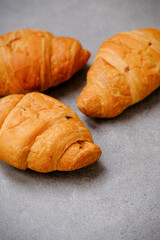 Fototapeta premium Fresh croissants on a kitchen table. Food style