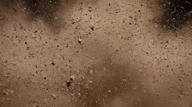 Brown dust particles exploding in sphere shape in dark environment