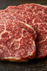 Obraz premium Freshly cut raw meat sits atop a table, ready for use