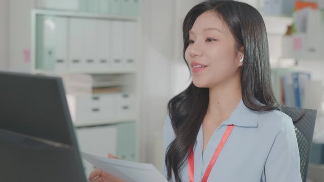 Young happy business woman having remote online work hybrid meeting or job interview. Young female employee looking at laptop during virtual video conference call in office.