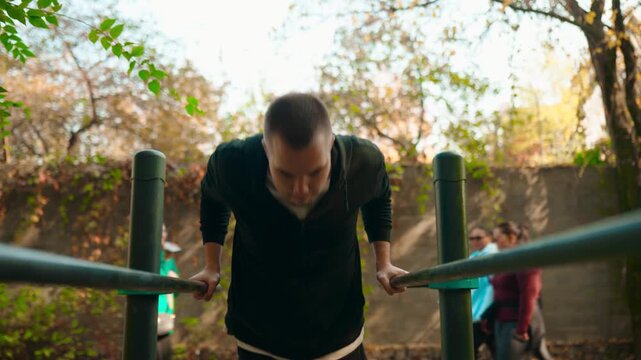 Man Doing Dips on Parallel Bars Outdoor Fitness Workout