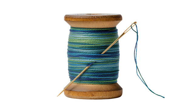 Isolated wooden spool of vibrant blue and green multicolored thread with a shiny golden sewing needle