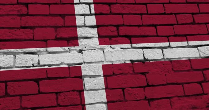 A panning video of a brick wall with the denmark flag
