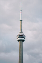 Obraz premium Famous Tower Skyline. Striking Tower Soars Under Somber Overcast Sky With Distant Cityscape