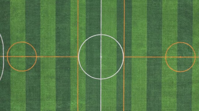 Aerial top view of soccer field with green artificial grass and field markings