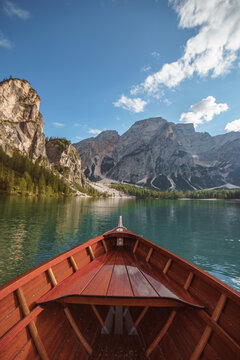 Wooden boat navigating lago di braies dolomites mountains lake