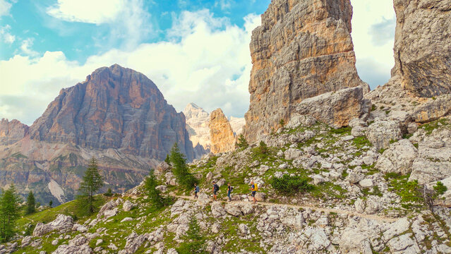 Hikers trekking mountain trail cinque torri dolomites italy