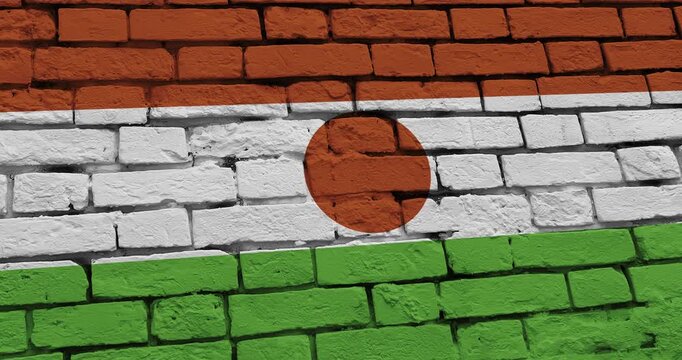 A panning video of a brick wall with the niger flag