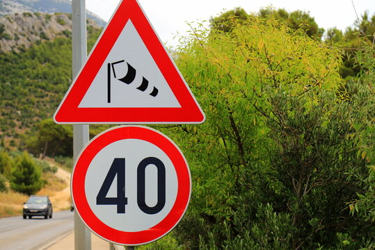 The Crosswind road sign warns of strong cross winds. Warning road sign on mountain road in Croatia