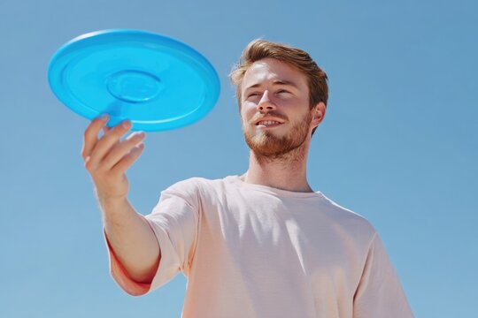 Man catching ultimate frisbee disk during outdoor sport