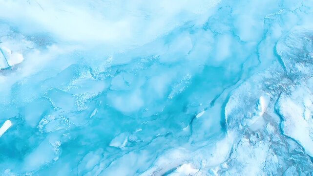 Winter season adventure exploration. A closeup view of a glaciers icy surface reveals intricate patterns and textures. The color palette is dominated by shades of blue, ranging from light to dark.