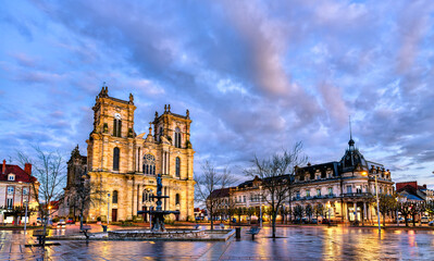 The illuminated Collegiate Church of Our Lady of the Assumption and fountain at dusk in Place d'Armes, Vitry le Francois, France.