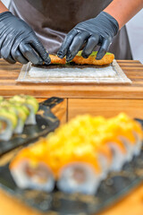 Chef hands preparing sushi maki roll fusion cuisine © Guillermo Spelucin