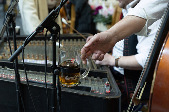 Hand holding beer mug at live music event