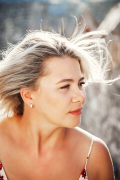 Woman enjoying a sunny day with wind in her hair