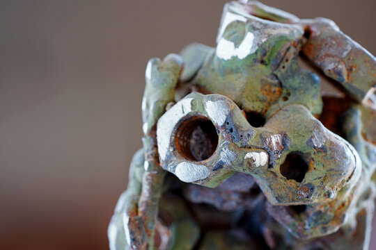 Abstract Industrial Sculpture Made of Welded Rusty Nuts and Scrap Metal with Gritty Texture