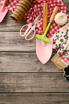 Gardening tools on rustic table with spring decor