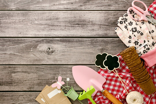 Gardening tools arranged on rustic wooden table