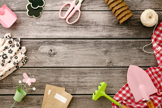 Gardening tools and accessories on wooden background