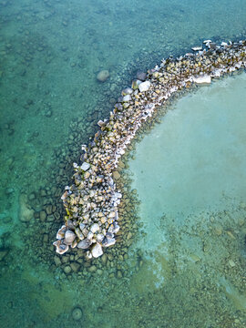 Aerial view of Lake Geneva's rocky shore from drone