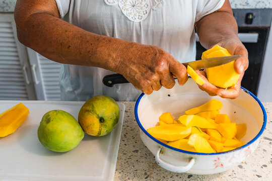 Preparing fresh mango in a tropical Caribbean kitchen